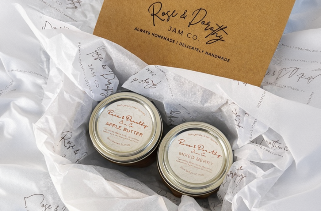 Two tins of Rose & Dorothy Jam on tissue paper in shipping package